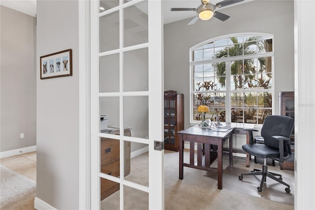 carpeted home office with ceiling fan