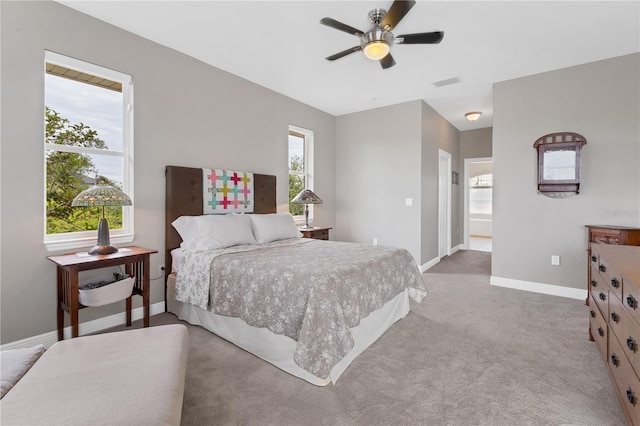 carpeted bedroom with ceiling fan and ensuite bathroom