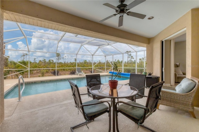 view of swimming pool with a patio and glass enclosure