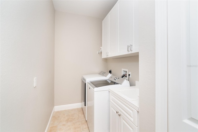 116 Hercules Dr, Rotonda West, FL 33947 - laundry room featuring cabinet space, washer and clothes dryer, baseboards, and light tile patterned floors