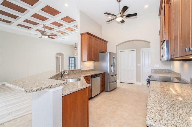 116 Hercules Dr, Rotonda West, FL 33947 - kitchen with arched walkways, ceiling fan, a sink, appliances with stainless steel finishes, and a peninsula