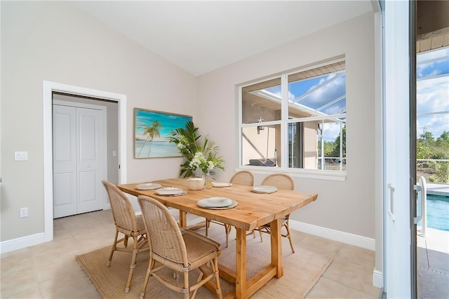 116 Hercules Dr, Rotonda West, FL 33947 - dining space with light tile patterned floors, vaulted ceiling, and baseboards
