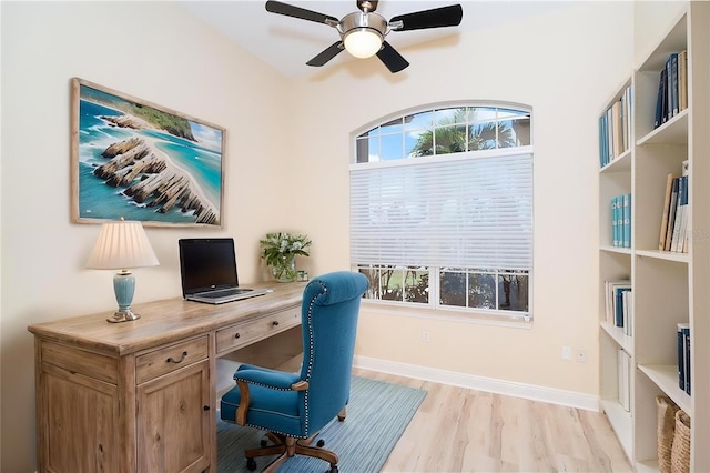 116 Hercules Dr, Rotonda West, FL 33947 - home office featuring light wood-type flooring, ceiling fan, and baseboards