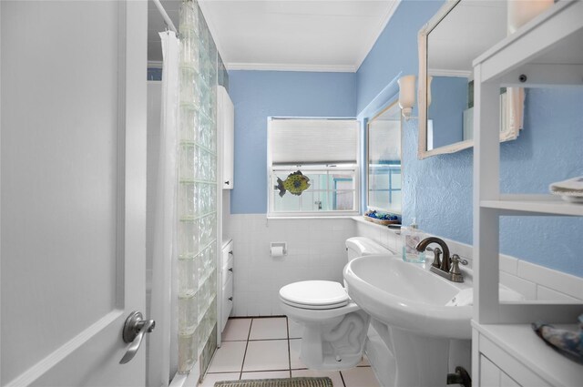 bathroom featuring toilet, ornamental molding, tile patterned floors, curtained shower, and tile walls