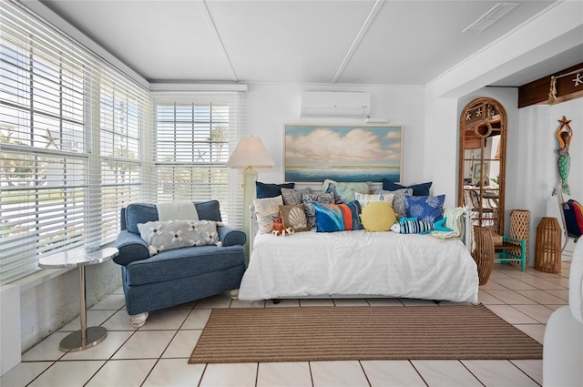 bedroom featuring a wall mounted air conditioner, visible vents, and tile patterned floors