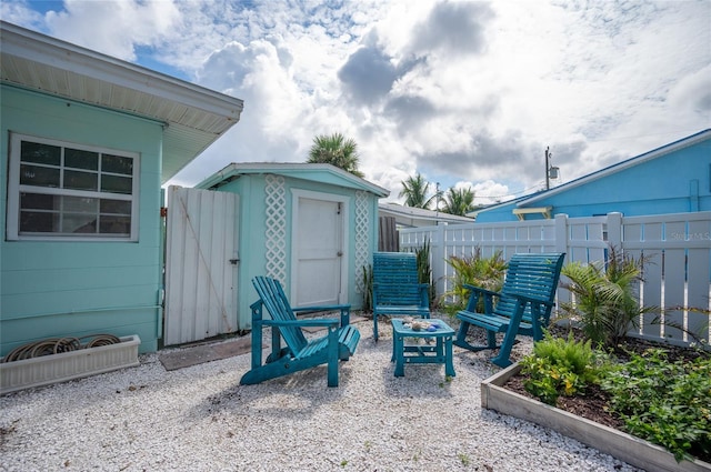 view of patio / terrace featuring a fire pit and fence