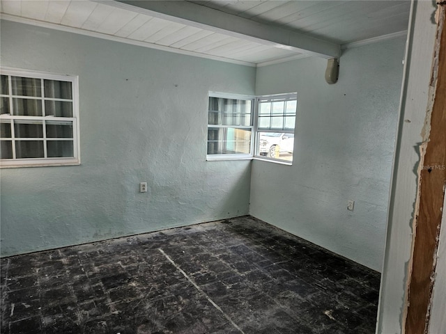 unfurnished room featuring a textured wall, beamed ceiling, and wooden ceiling