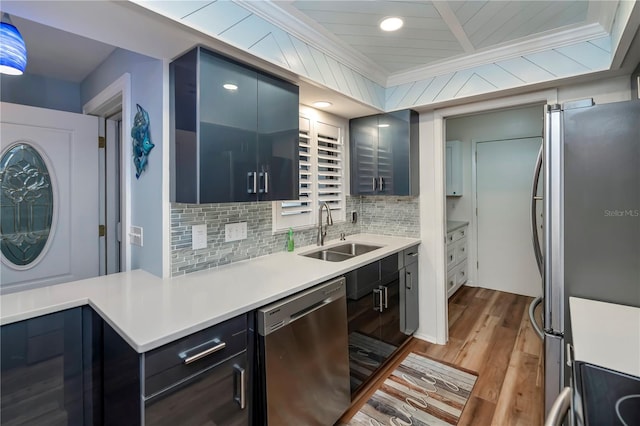 kitchen with tasteful backsplash, sink, light hardwood / wood-style flooring, and stainless steel appliances