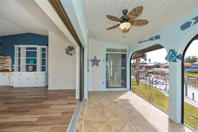 interior space featuring a water view and ceiling fan