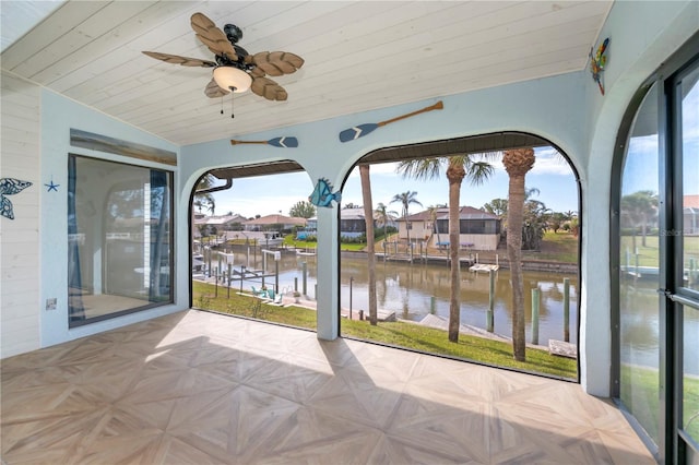 sunroom / solarium with vaulted ceiling, a water view, and ceiling fan