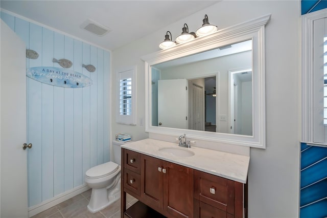 bathroom featuring vanity, tile patterned floors, and toilet