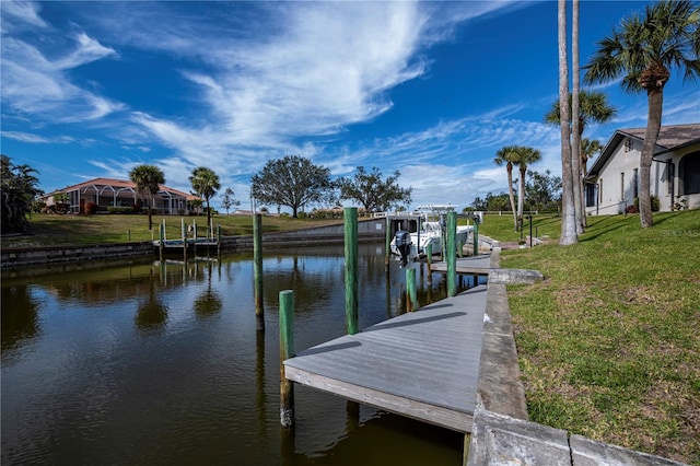 view of dock featuring a lawn and a water view