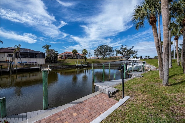 dock area featuring a water view and a lawn