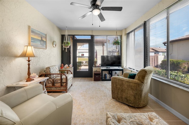 tiled living room with ceiling fan