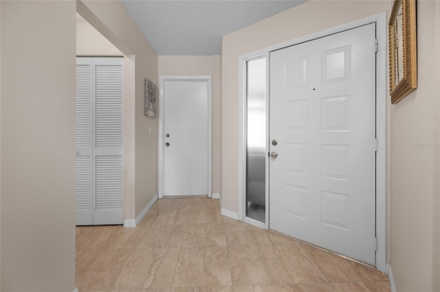 foyer with a textured ceiling