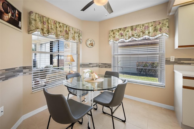 dining room with ceiling fan, a healthy amount of sunlight, and light tile patterned floors