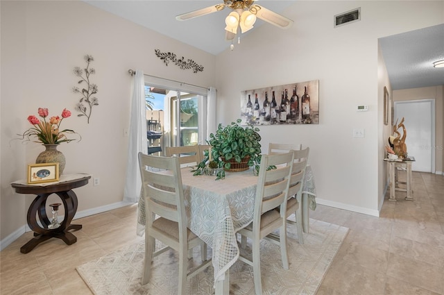 dining space featuring light tile patterned flooring and ceiling fan