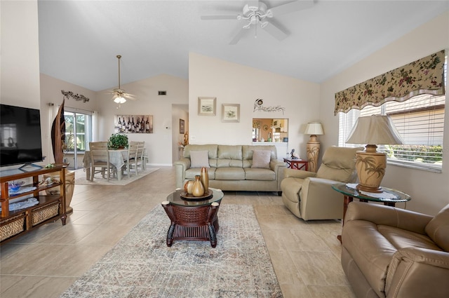 living room featuring lofted ceiling, ceiling fan, and a healthy amount of sunlight