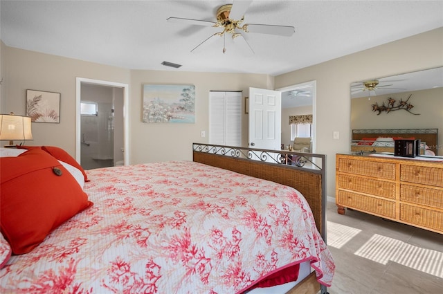 bedroom featuring ceiling fan, ensuite bathroom, and a closet