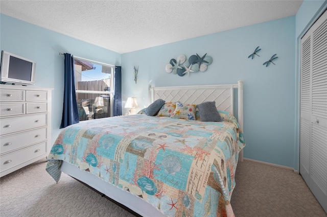 carpeted bedroom featuring a closet and a textured ceiling