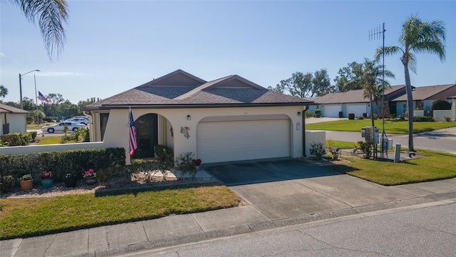 view of front of home featuring a front yard and a garage