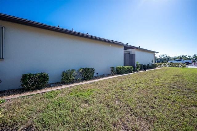 view of side of home featuring a lawn