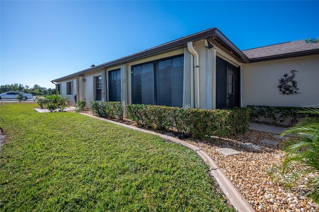 view of side of home featuring a yard