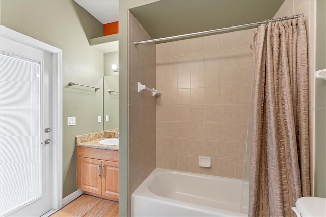 bathroom featuring wood-type flooring, vanity, and shower / bath combo with shower curtain