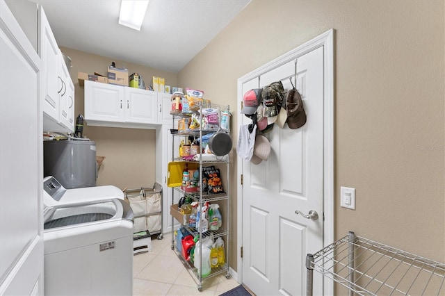 washroom with cabinets, washer and clothes dryer, gas water heater, and light tile patterned floors