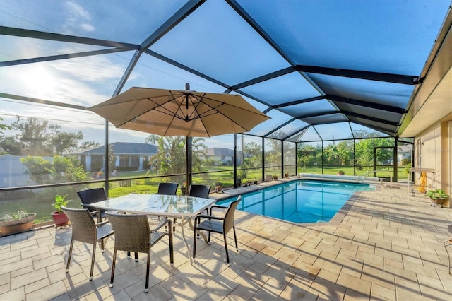 view of swimming pool with a patio and glass enclosure