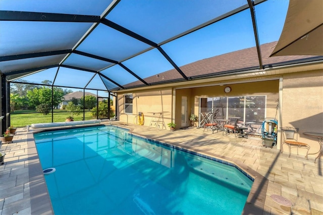 view of swimming pool with a lanai and a patio