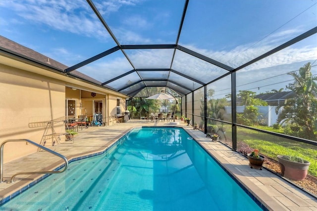 view of pool featuring a patio area and glass enclosure