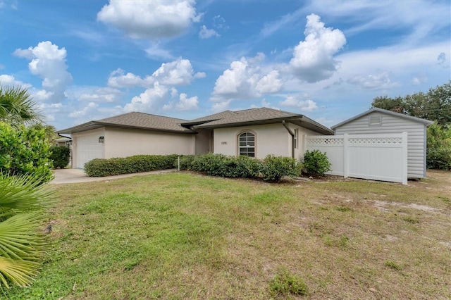 single story home with a front yard and a garage