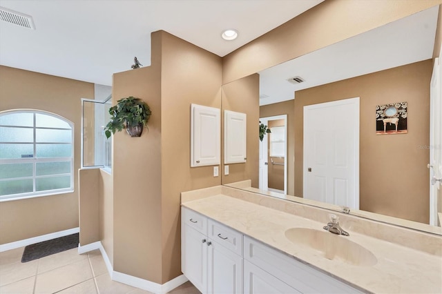 bathroom with vanity, tile patterned flooring, and walk in shower