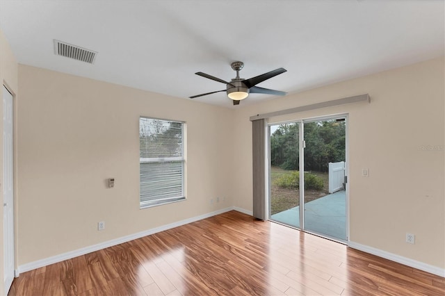 spare room featuring light hardwood / wood-style floors and ceiling fan