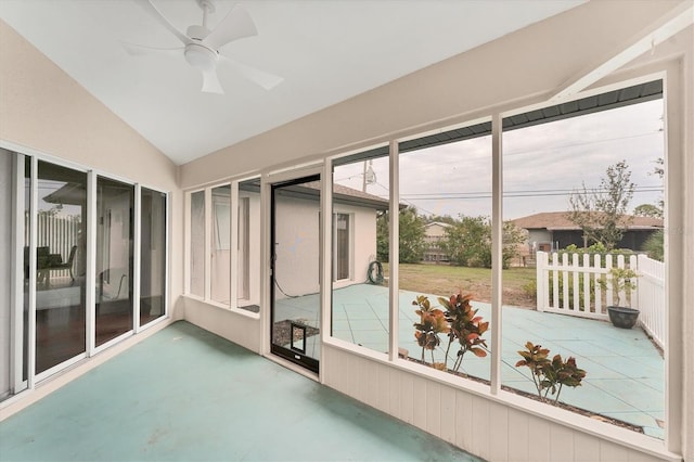 unfurnished sunroom with ceiling fan and vaulted ceiling