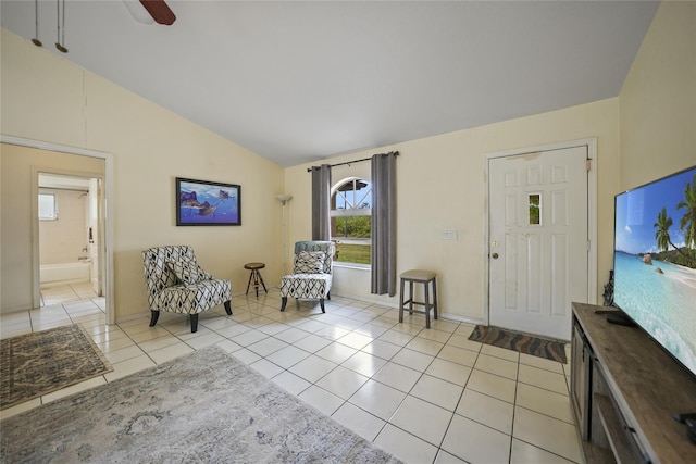 tiled entryway featuring ceiling fan and lofted ceiling