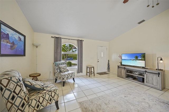 tiled living room featuring ceiling fan and vaulted ceiling