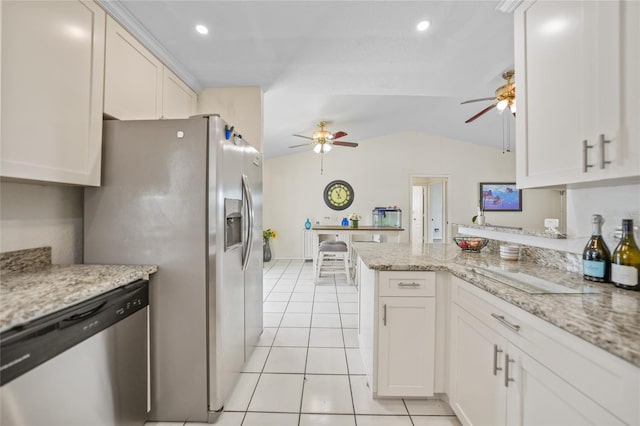 kitchen featuring appliances with stainless steel finishes, kitchen peninsula, light stone countertops, white cabinets, and light tile patterned flooring