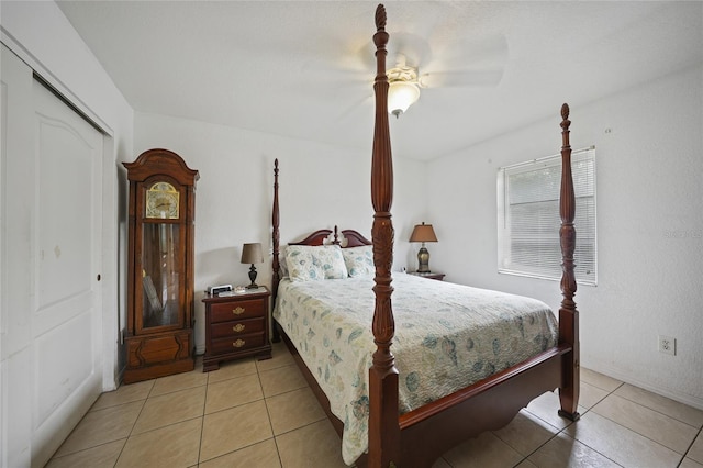 tiled bedroom with ceiling fan and a closet