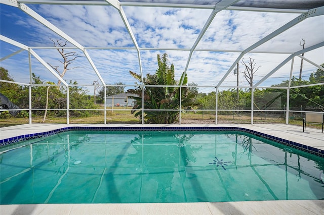 view of swimming pool with a lanai and a patio