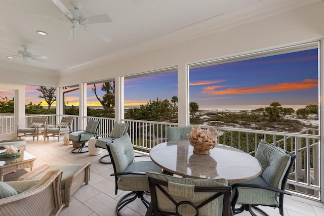 sunroom featuring ceiling fan