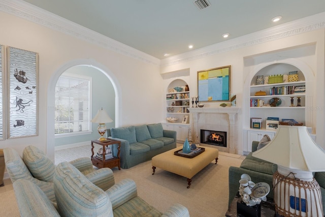 living room featuring light colored carpet, a tile fireplace, and built in shelves