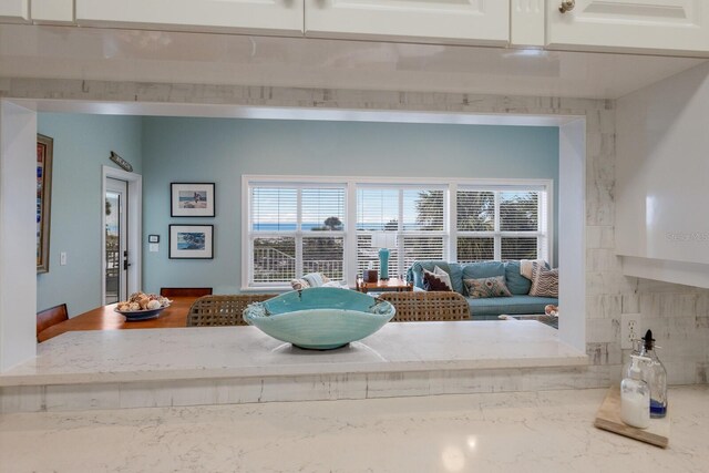 room details with white cabinetry and light stone countertops