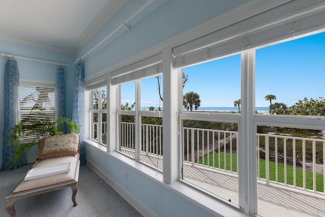 sunroom / solarium featuring a water view