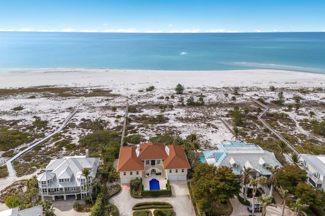 bird's eye view with a water view and a beach view