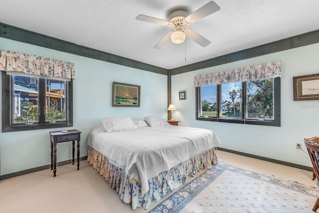 bedroom with ceiling fan and carpet