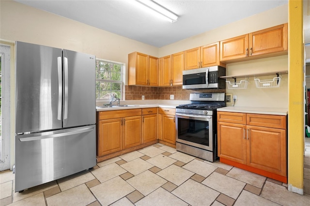 kitchen with decorative backsplash, sink, and stainless steel appliances