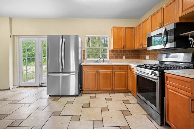 kitchen featuring tasteful backsplash, sink, and stainless steel appliances