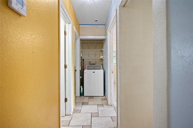 hallway with light tile patterned flooring and washer / clothes dryer